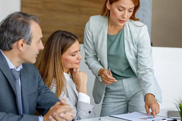 Three colleagues going through an annual report filing together