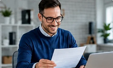 A small business owner reading a tax notice at a desk
